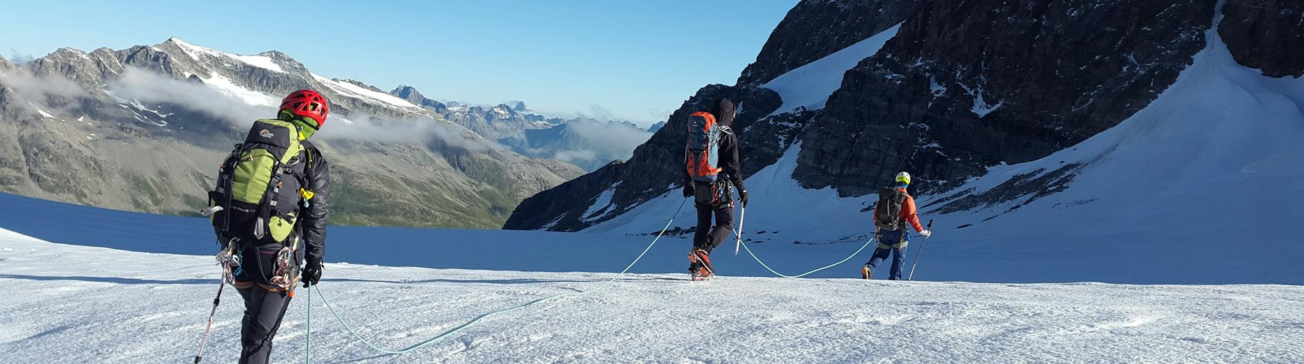 man walking on snow covered mountain